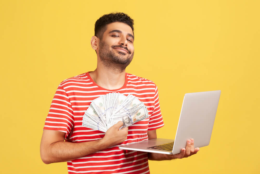 Complacent,Self,Confident,Man,Smiling,Holding,In,Hands,Laptop,And