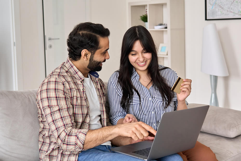 Happy,Indian,Family,Couple,Shoppers,Customers,Using,Laptop,Computer,Doing